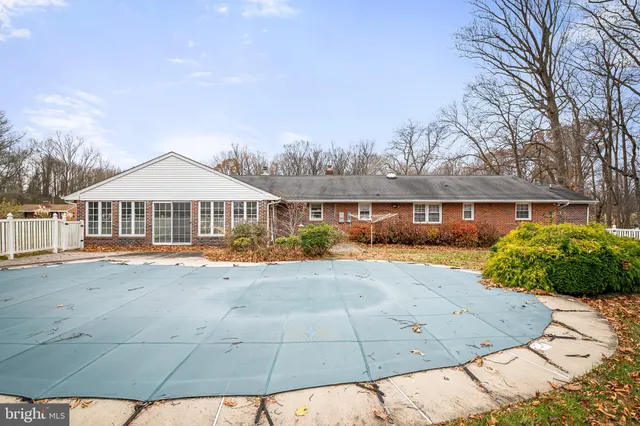 a front view of a house with a yard and lake view