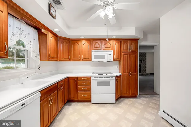 a kitchen with stainless steel appliances granite countertop a sink and a refrigerator