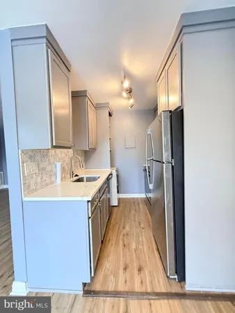 a bathroom with a sink a mirror and a shower