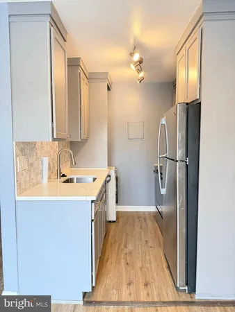 a bathroom with a sink a mirror and a shower
