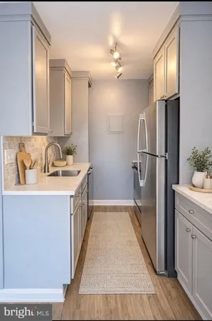 a bathroom with a sink a mirror and a shower