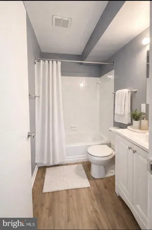 a bathroom with a toilet a sink and a shower