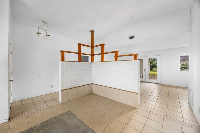 a kitchen with white cabinets and appliances