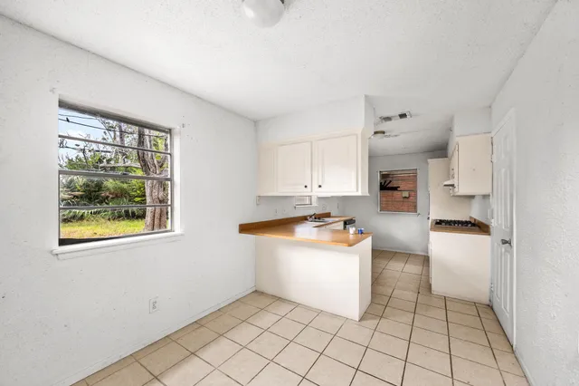 a large kitchen with stainless steel appliances granite countertop a sink and cabinets