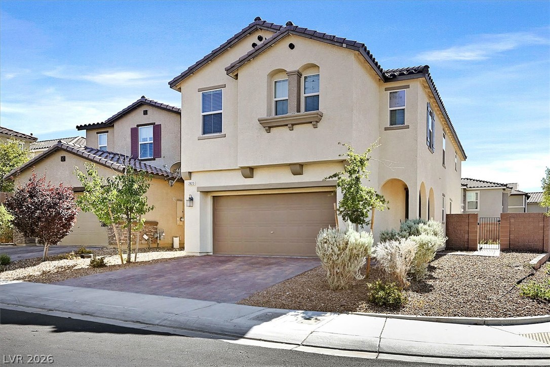 2823 Turnstone Ridge Street Henderson, NV 89044 - Photo 1 of 25 A classic stucco facade with a terracotta roof offers timeless curb appeal.
