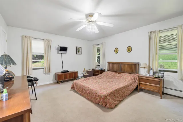 a spacious bedroom with a bed and a chandelier