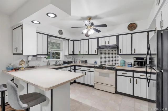 a kitchen with a sink a stove and cabinets
