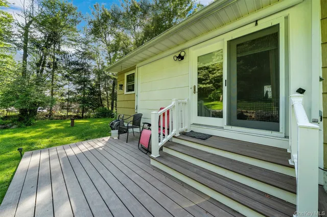 a view of a wooden deck with a yard