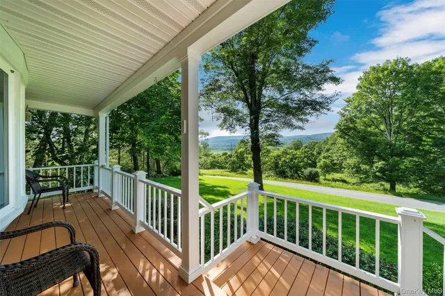 a view of a wooden deck next to a yard