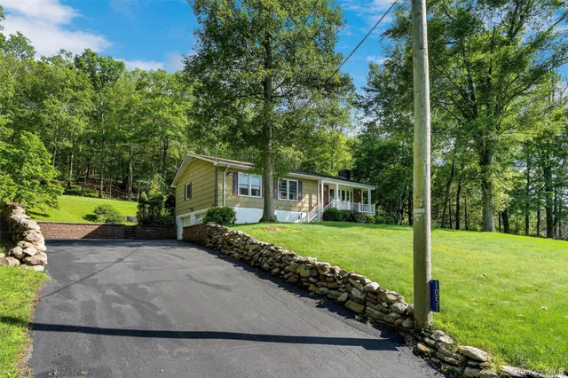 a view of a house with a yard and a garden