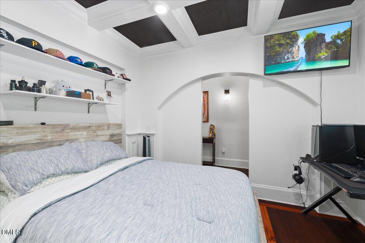 1304 Flying Hawk Road Apex, NC 27523 - Photo 7 of 52 a bedroom with a bed and a flat screen tv