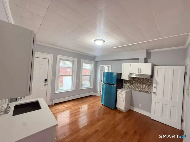 a kitchen with a refrigerator and a stove top oven