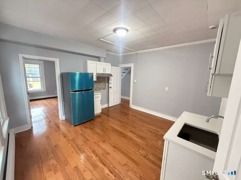 276 Pequonnock Street, Unit 1 Bridgeport, CT 06604 - Photo 2 of 9 a kitchen with a refrigerator and a sink