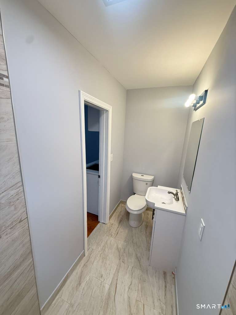 276 Pequonnock Street, Unit 1 Bridgeport, CT 06604 - Photo 8 of 9 a bathroom with a toilet sink and a mirror