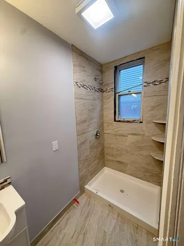 a bathroom with a shower and a tub