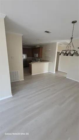 a view of a kitchen with a sink and cabinets