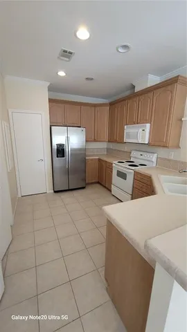 a kitchen with a cabinets and steel appliances