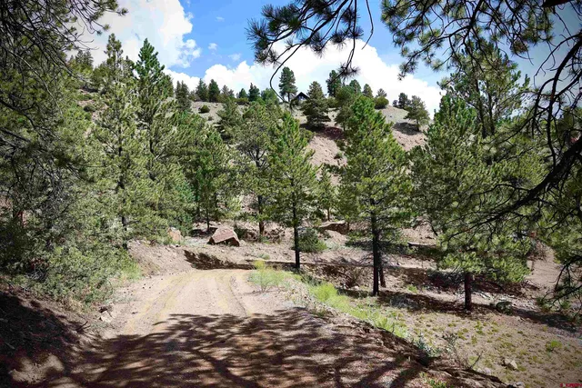 a view of a backyard of the house with outdoor seating