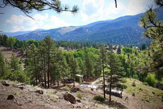 a view of a large mountain with a mountain in the background