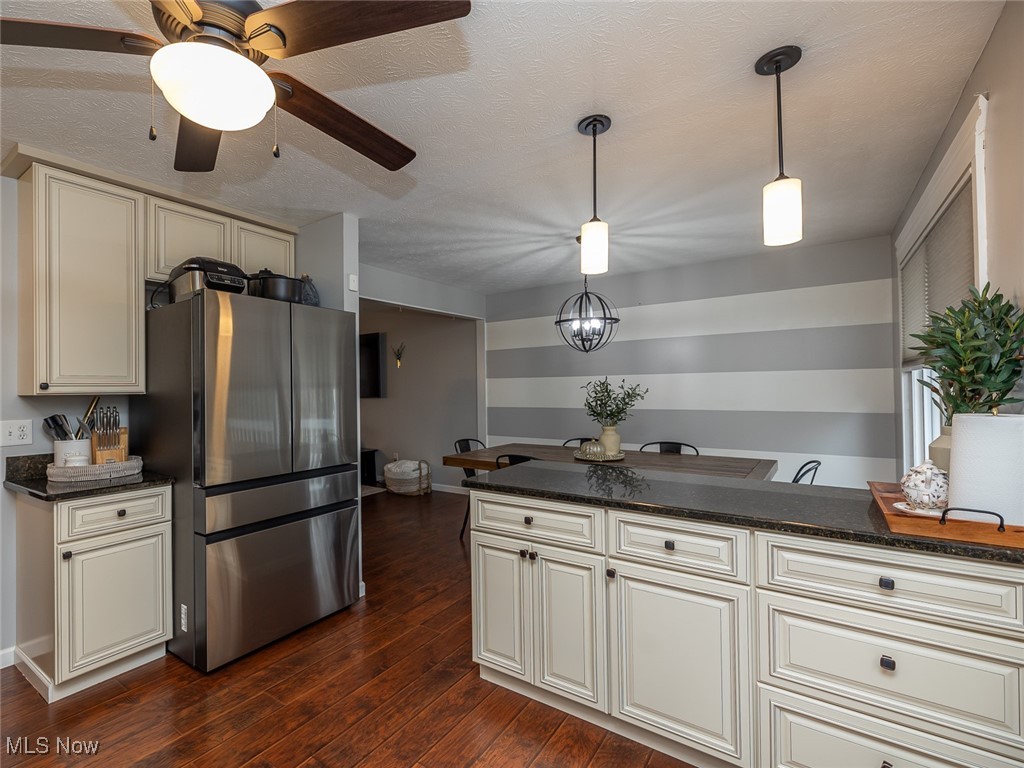 1060 Ledge Road Macedonia, OH 44056 - Photo 19 of 26 Kitchen with kitchen peninsula, stainless steel fridge, cream cabinets, and hanging light fixtures