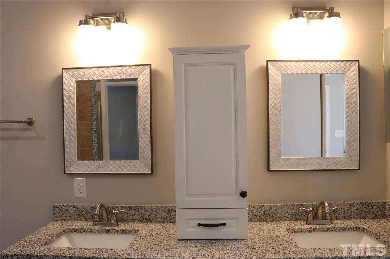 5713 Edgebury Road Raleigh, NC 27613 - Photo 17 of 26 a bathroom with a granite countertop sink and a mirror