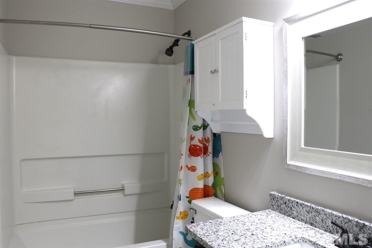 5713 Edgebury Road Raleigh, NC 27613 - Photo 21 of 26 a bedroom with a bed and a window