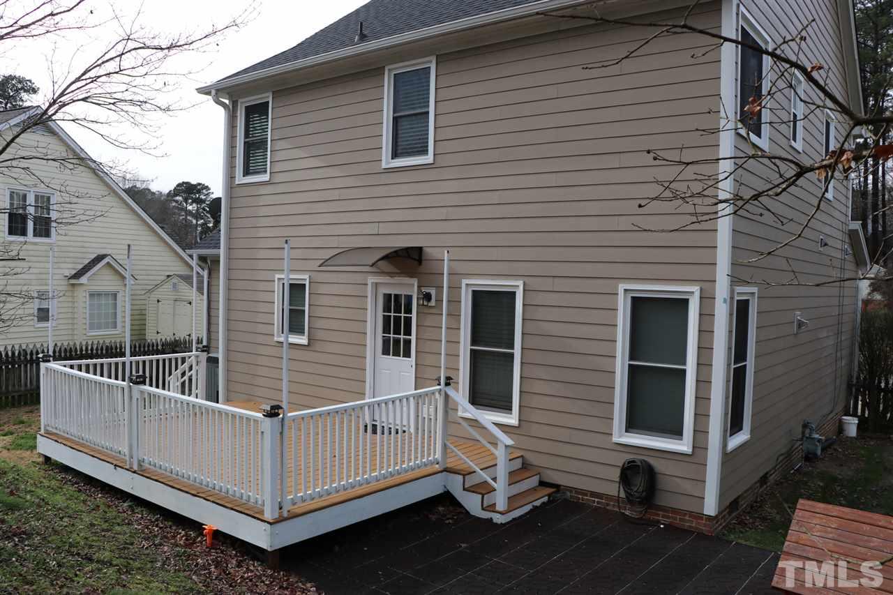 5713 Edgebury Road Raleigh, NC 27613 - Photo 25 of 26 a view of a white house with a small yard and wooden fence
