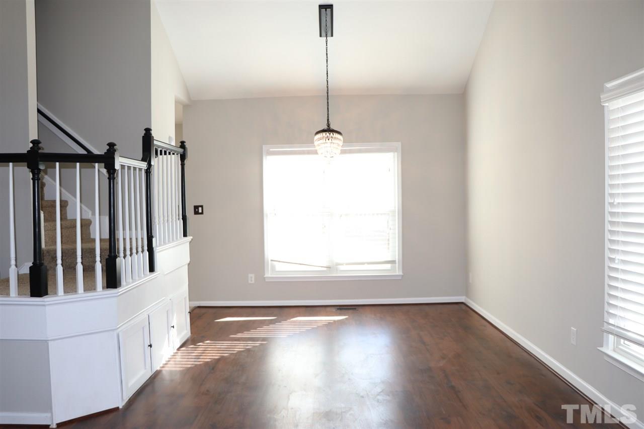 5713 Edgebury Road Raleigh, NC 27613 - Photo 7 of 26 a view of a room with wooden floor windows and a chandelier