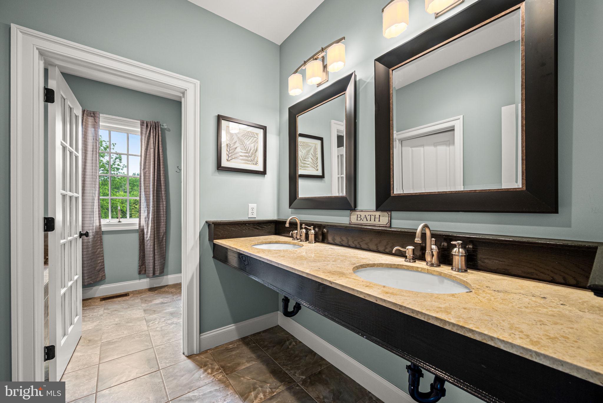 1548 Morstein Road Malvern, PA 19355 - Photo 50 of 80 a bathroom with a granite countertop sink and a mirror