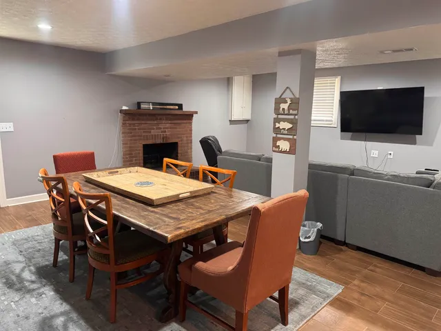 a dining room with a wooden table and chairs