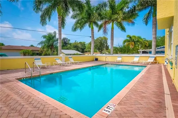 a view of swimming pool with outdoor seating and yard