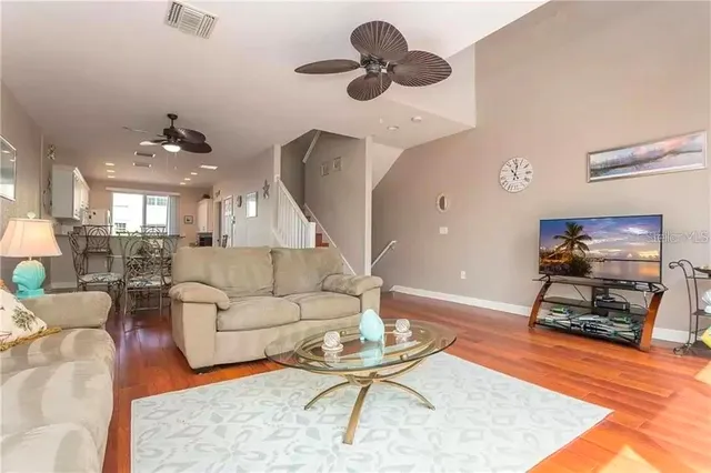 a living room with furniture a dining table and a piano