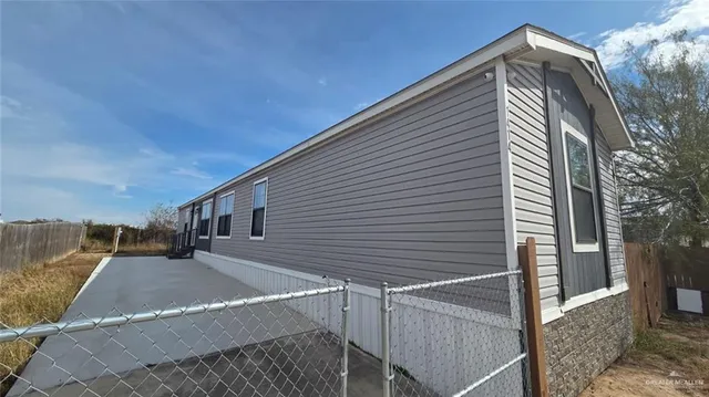 a view of entryway with wooden floor and fence