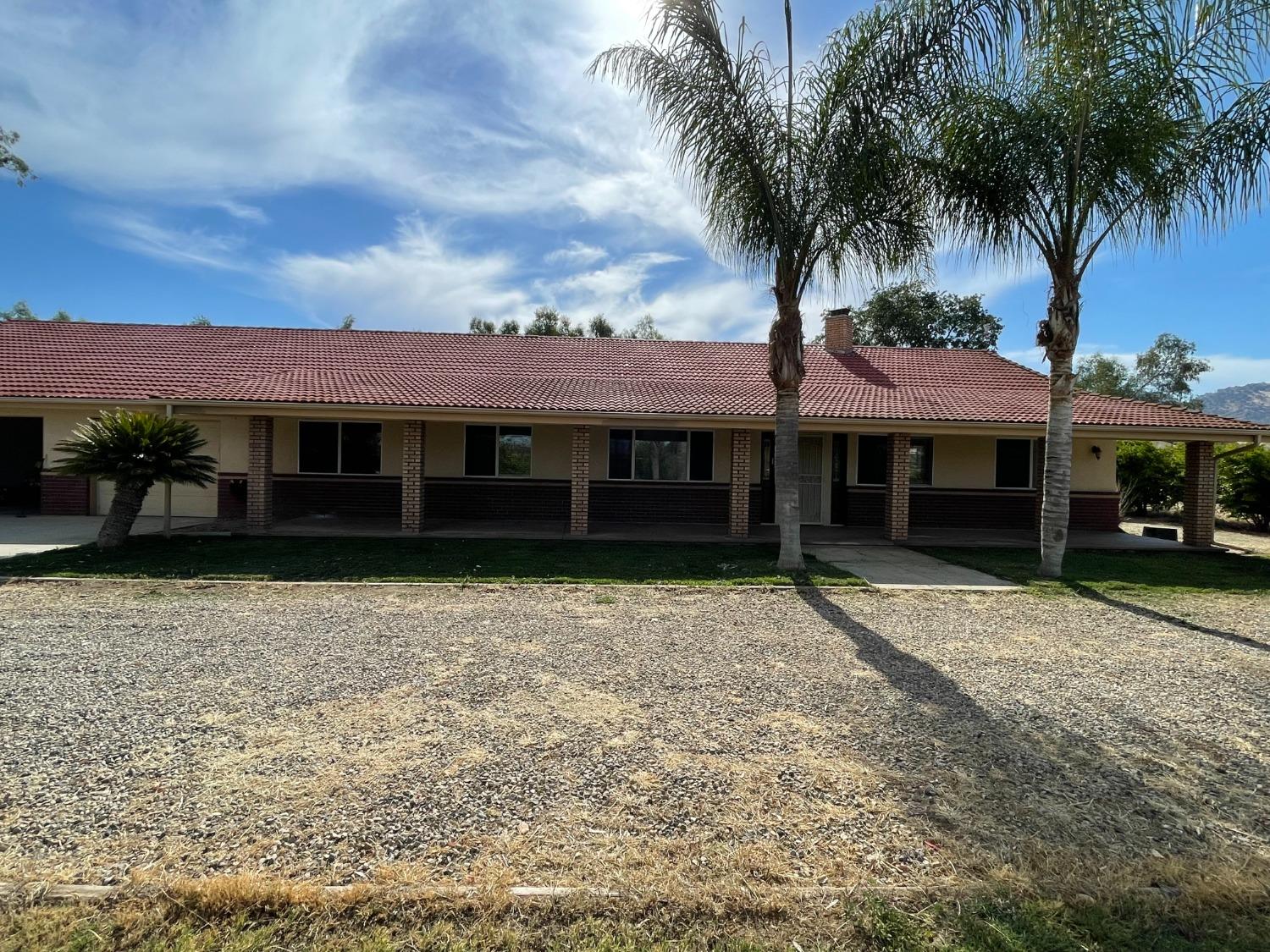 2344 Tivy Valley Road Sanger, CA 93657 - Photo 1 of 61 a front view of a house with a garden