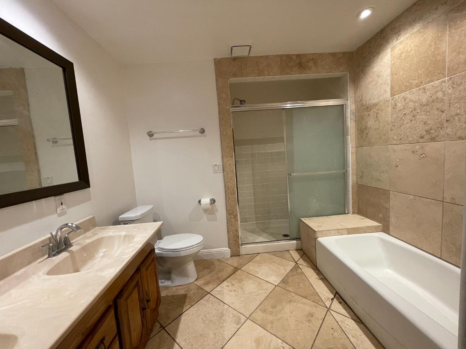 2344 Tivy Valley Road Sanger, CA 93657 - Photo 11 of 61 a bathroom with a sink a toilet and shower