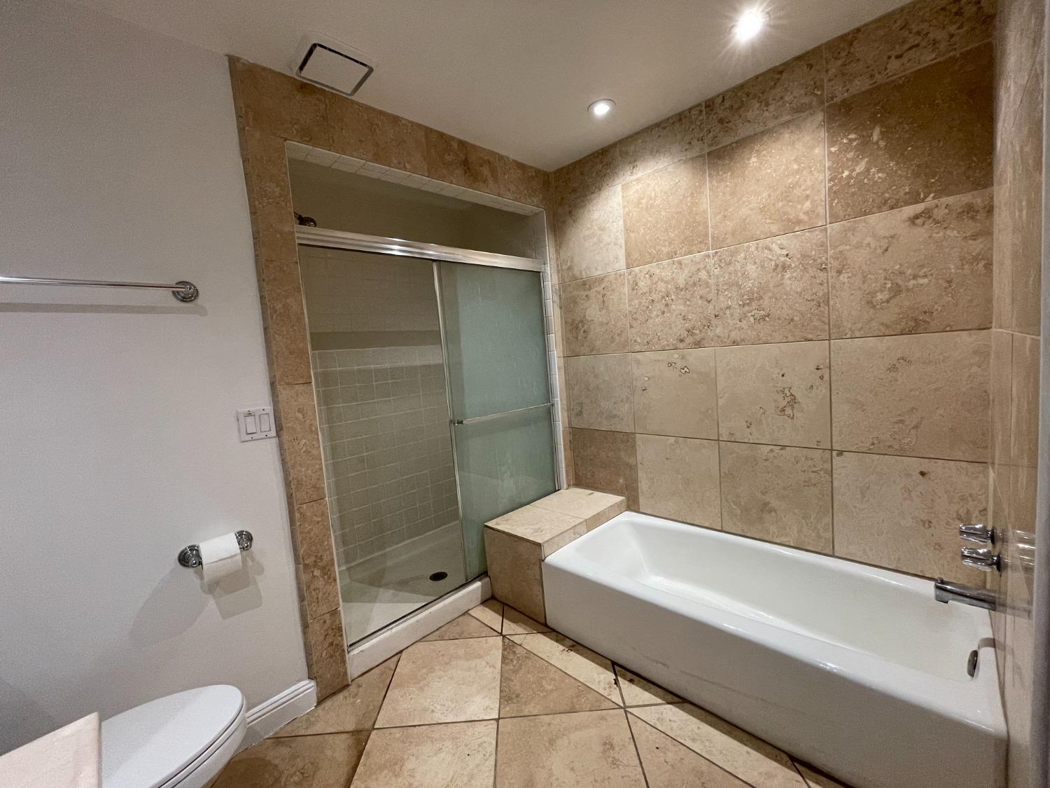 2344 Tivy Valley Road Sanger, CA 93657 - Photo 12 of 61 a bathroom with a bathtub and a shower