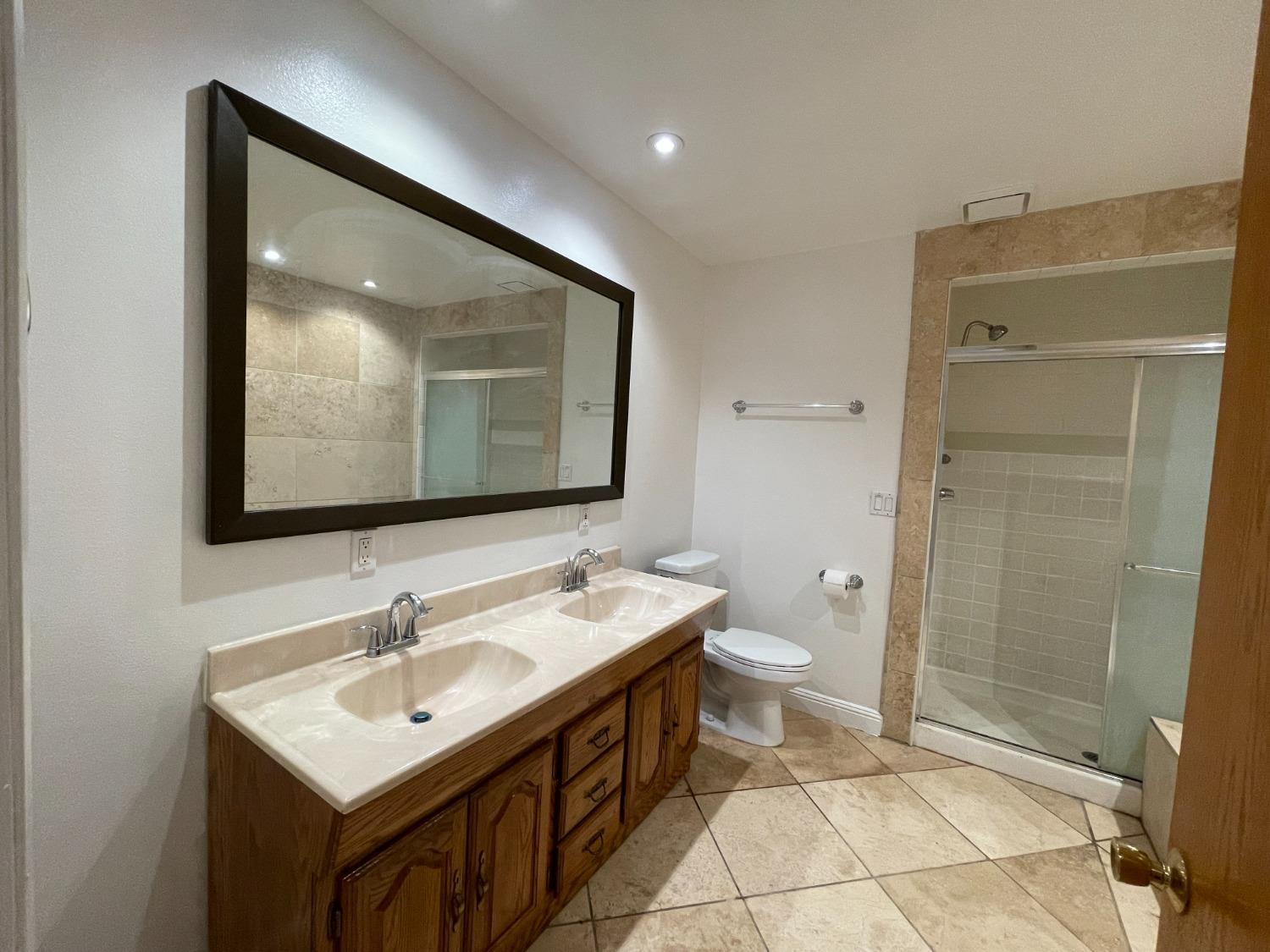 2344 Tivy Valley Road Sanger, CA 93657 - Photo 13 of 61 a bathroom with a double vanity sink mirror and toilet
