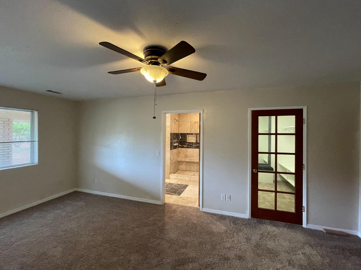 2344 Tivy Valley Road Sanger, CA 93657 - Photo 15 of 61 an empty room with windows and fan