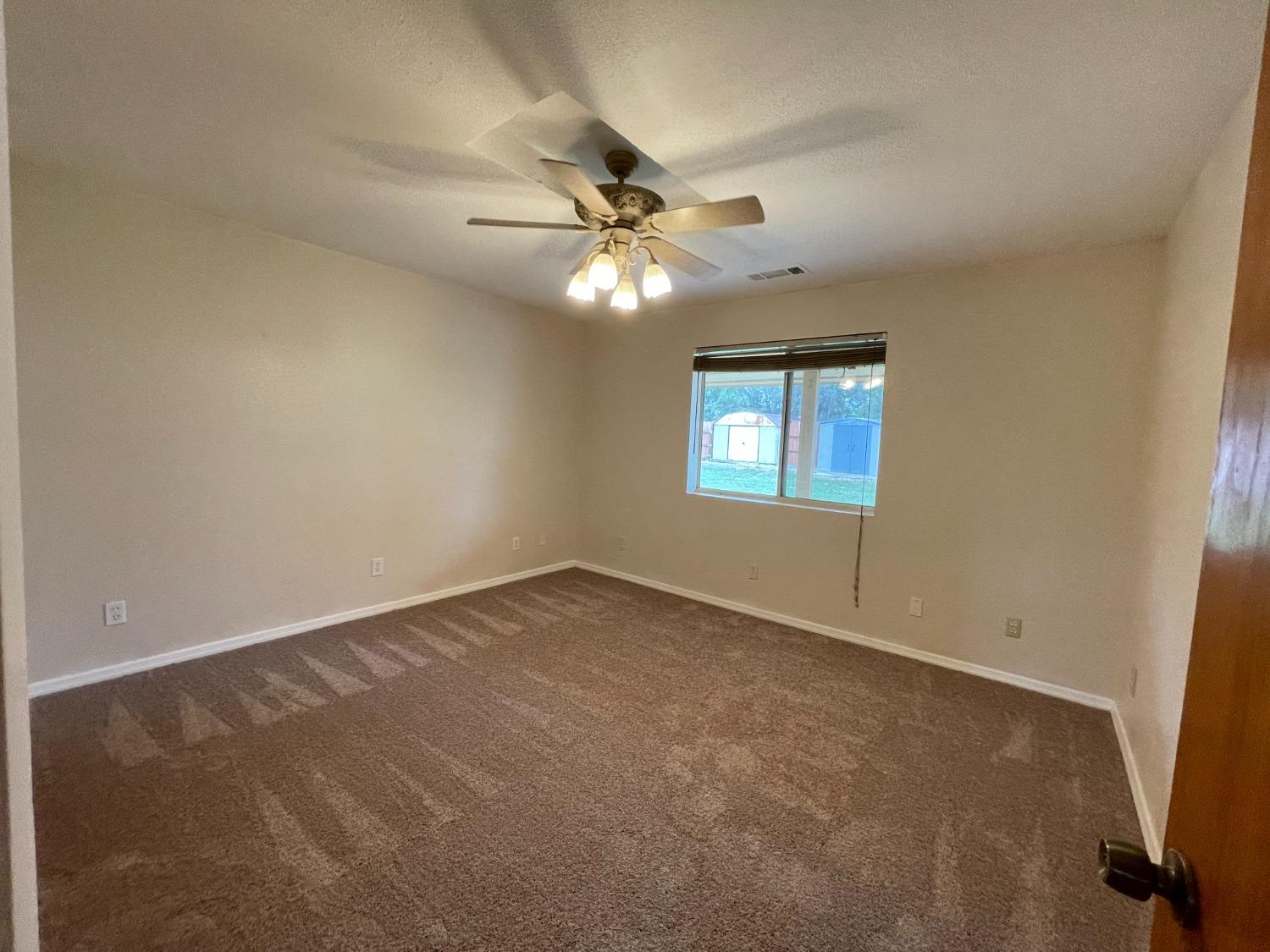 2344 Tivy Valley Road Sanger, CA 93657 - Photo 24 of 61 an empty room with a window and a fan