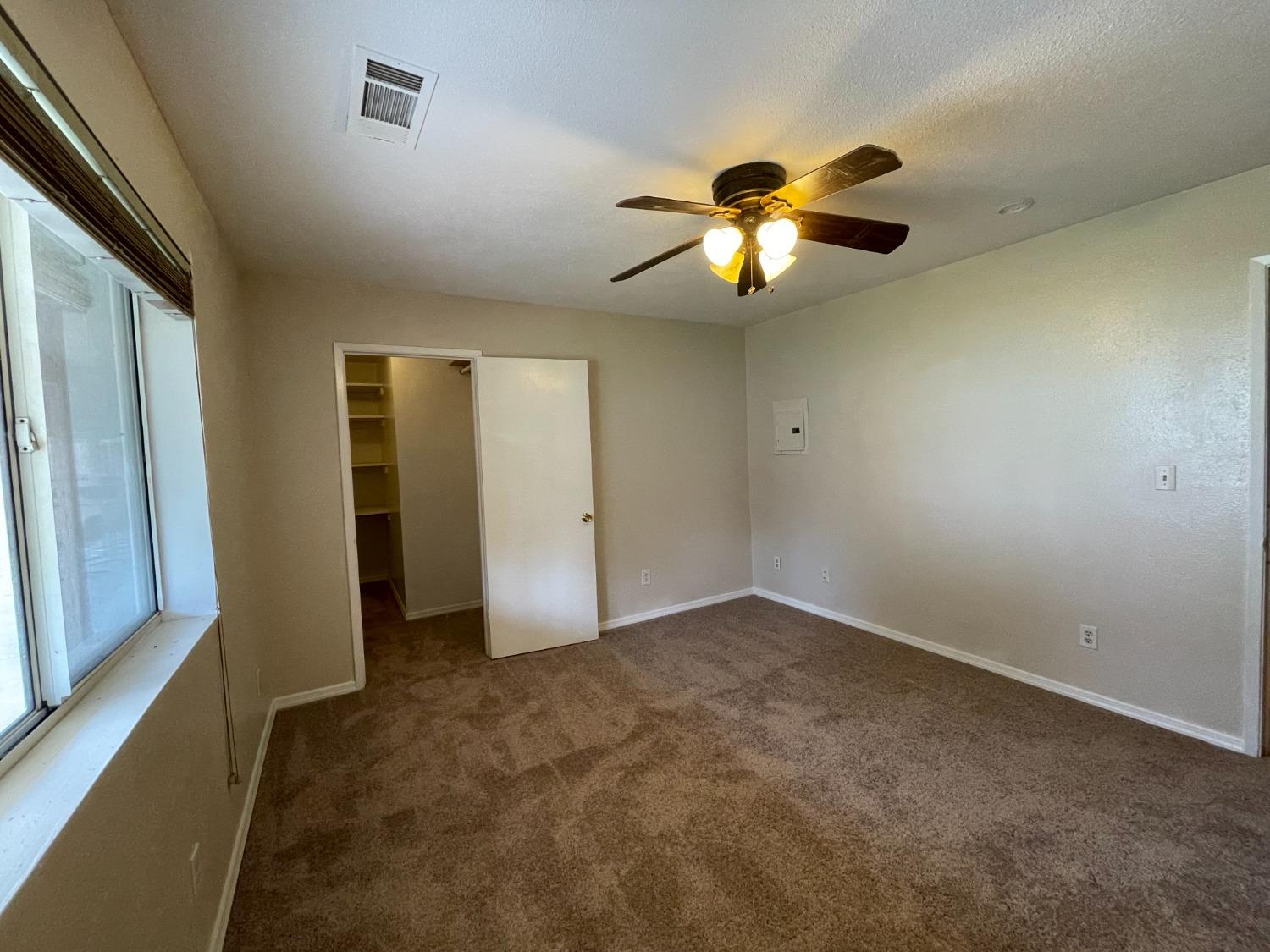 2344 Tivy Valley Road Sanger, CA 93657 - Photo 27 of 61 an empty room with closet and a chandelier fan