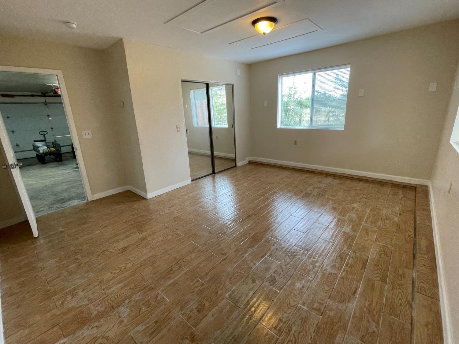 2344 Tivy Valley Road Sanger, CA 93657 - Photo 29 of 61 an empty room with wooden floor and windows