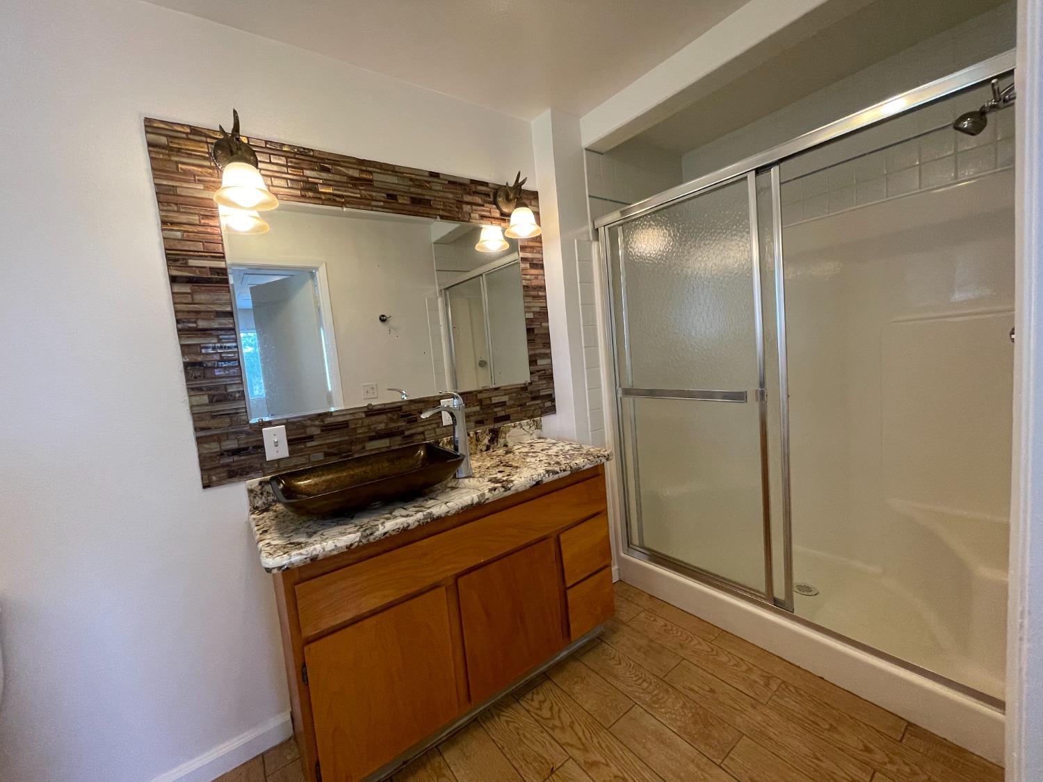 2344 Tivy Valley Road Sanger, CA 93657 - Photo 31 of 61 a bathroom with a granite countertop sink and a mirror