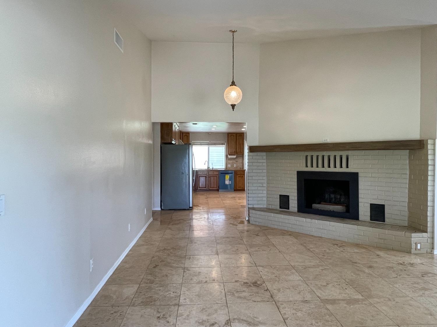 2344 Tivy Valley Road Sanger, CA 93657 - Photo 4 of 61 a view of an empty room with a fireplace and a window