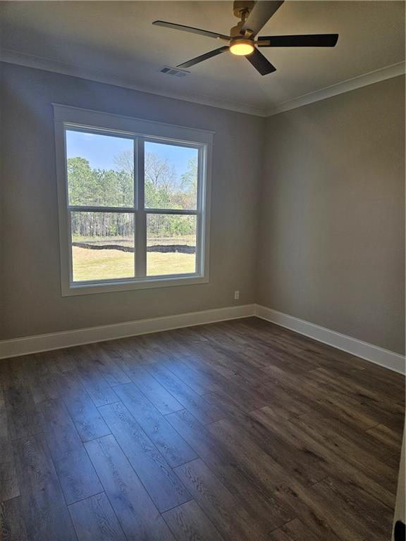 614 Old Tucker Road Stone Mountain, GA 30087 - Photo 15 of 29 an empty room with wooden floor and windows