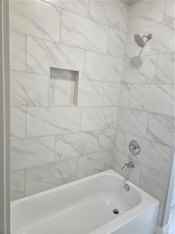 614 Old Tucker Road Stone Mountain, GA 30087 - Photo 16 of 29 a bathroom with a bathtub