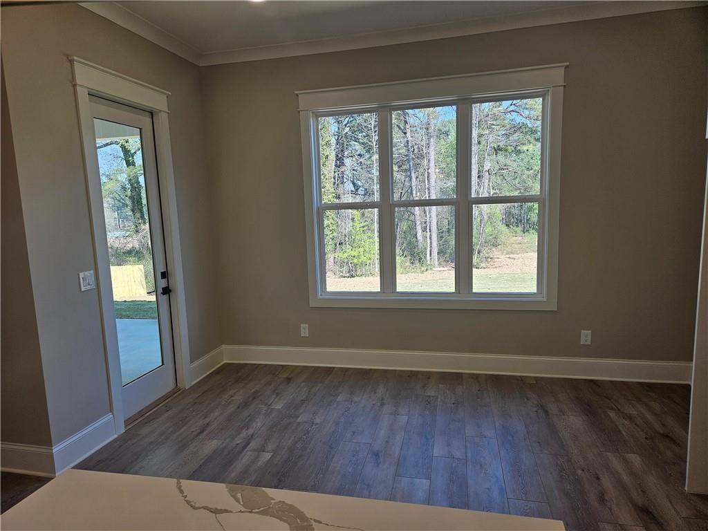 614 Old Tucker Road Stone Mountain, GA 30087 - Photo 17 of 29 an empty room with wooden floor and windows