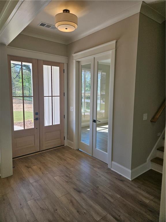 614 Old Tucker Road Stone Mountain, GA 30087 - Photo 2 of 29 an empty room with wooden floor and windows