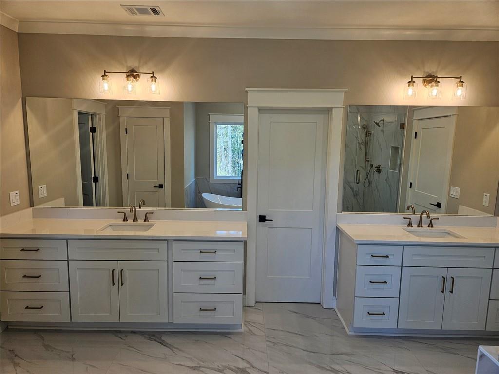 614 Old Tucker Road Stone Mountain, GA 30087 - Photo 23 of 29 a spacious bathroom with double sink and a large mirror