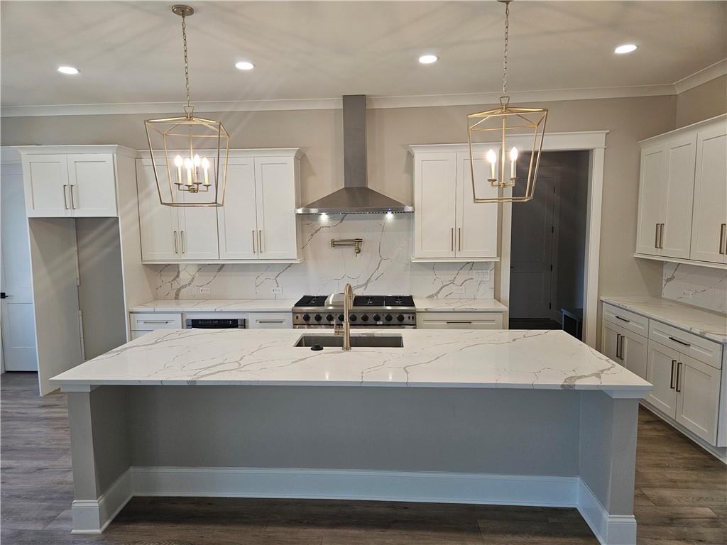 614 Old Tucker Road Stone Mountain, GA 30087 - Photo 3 of 29 a kitchen with stainless steel appliances a refrigerator a sink dishwasher a stove and white cabinets with wooden floor