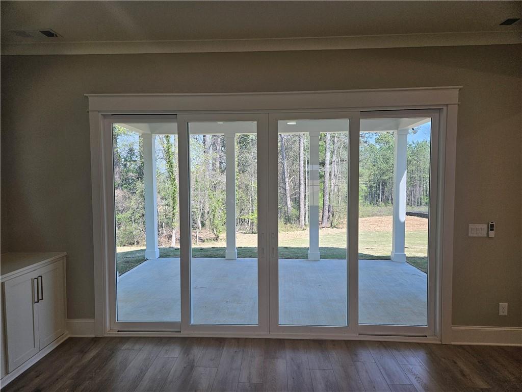 614 Old Tucker Road Stone Mountain, GA 30087 - Photo 7 of 29 a view of an empty room with wooden floor and windows